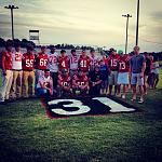 Football team gathered around Ryan's number. Death The Kid #12 and ShadowLucario #55